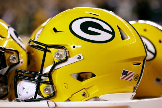 A Green Bay Packers helmet sits on the sidelines during an NFL football game against the Philadelphia Eagles, Sunday, Nov. 27, 2022, in Philadelphia. John Gordon, an artist who as a young art student helped design the Green Bay Packers’ distinctive “G” team logo, died Saturday, Sept. 30, 2023, at age 83. (AP Photo/Rich Schultz)