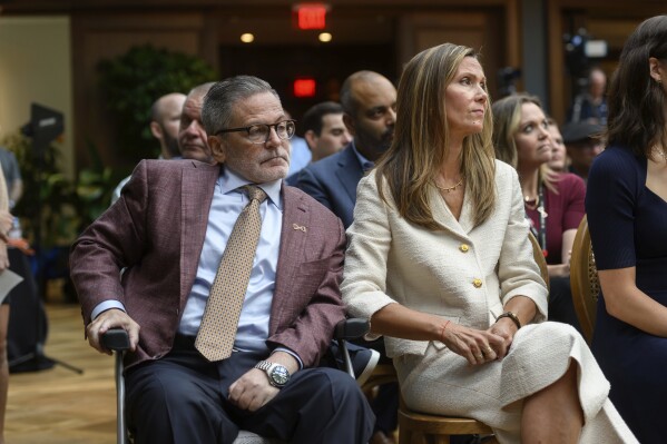 Dan and Jennifer Gilbert sit in the audience during a press conference at the Book Tower in Detroit, Wednesday, Sept. 6, 2023, to announce a nearly $375 million philanthropic effort to fight strokes and research cures for neurofibromatosis. (David Guralnick/Detroit News via AP)