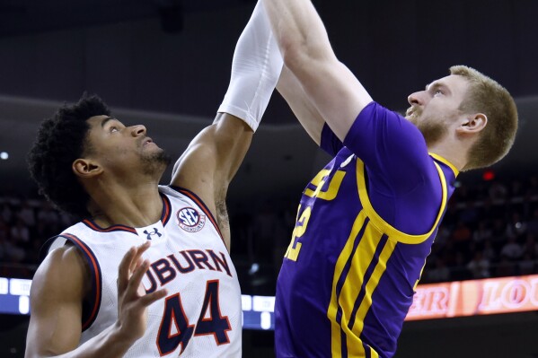 Auburn center Dylan Cardwell (44) blocks the shot of LSU forward Hunter Dean (12) during the first half of an NCAA college basketball game Saturday, Jan. 13, 2024, in Auburn, Ala. (AP Photo/Butch Dill)