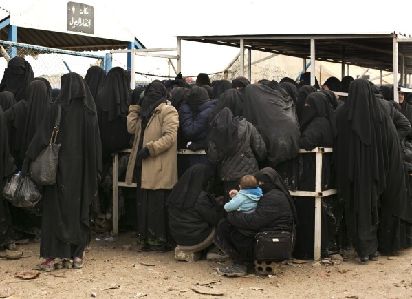 FILE - Women residents from former Islamic State-held areas in Syria line up for aid supplies at Al-Hol camp in Hassakeh province, Syria, March 31, 2019. Amnesty International said Wednesday, April 17, 2024 it has documented widespread abuses, including torture and deprivation of medical care, in detention facilities holding thousands of suspected Islamic State members and their relatives in northeast Syria. (AP Photo/Maya Alleruzzo, File)
