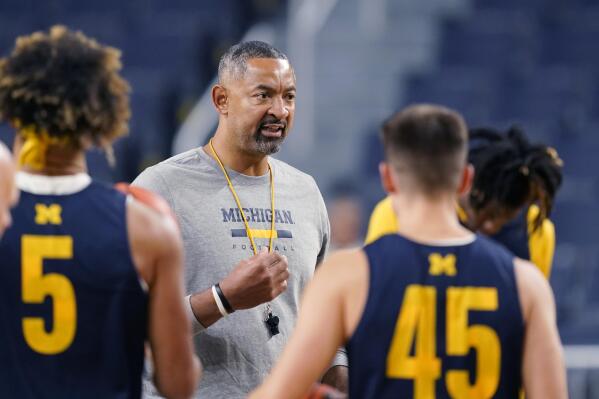 Michigan head basketball coach Juwan Howard talks to the team during a team practice, Friday, Oct. 14, 2022, in Ann Arbor, Mich. The 22nd-ranked team features three Howards this season. Juwan Howard is entering his fourth season as coach, and his first with two sons on the team. Highly touted freshman Jett Howard is expected to be in the starting lineup on the wing. Junior Jace Howard will have an opportunity to play a larger role this season after being a seldom-used reserve during his first two years.(AP Photo/Carlos Osorio)