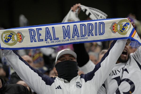 Real Madrid fans cheer during the Champions League quarterfinal second leg soccer match between Manchester City and Real Madrid at the Etihad Stadium in Manchester, England, Wednesday, April 17, 2024. (AP Photo/Dave Shopland)