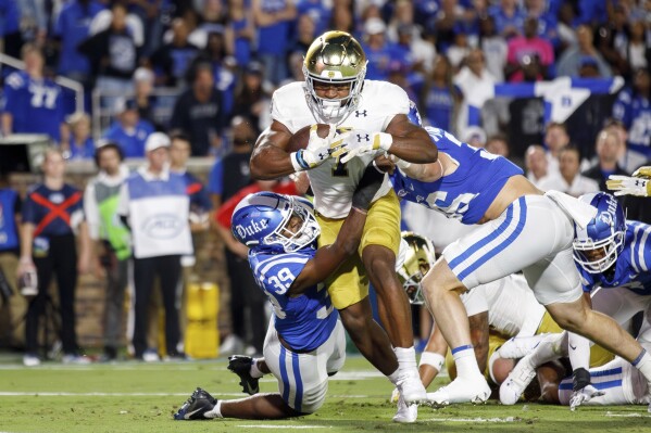 Notre Dame's Audric Estimé (7) carries the ball for a touchdown past Duke's Jeremiah Lewis (39) during the first half of an NCAA college football game in Durham, N.C., Saturday, Sept. 30, 2023. (AP Photo/Ben McKeown)