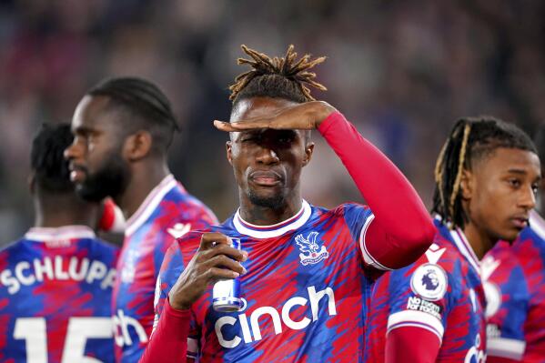 Crystal Palace's Wilfried Zaha, centre, gestures. ahead of the English Premier League soccer match between Crystal Palace and Wolverhampton Wanderers at Selhurst Park, London, Tuesday, Oct. 18, 2022. (Zac Goodwin/PA via AP)
