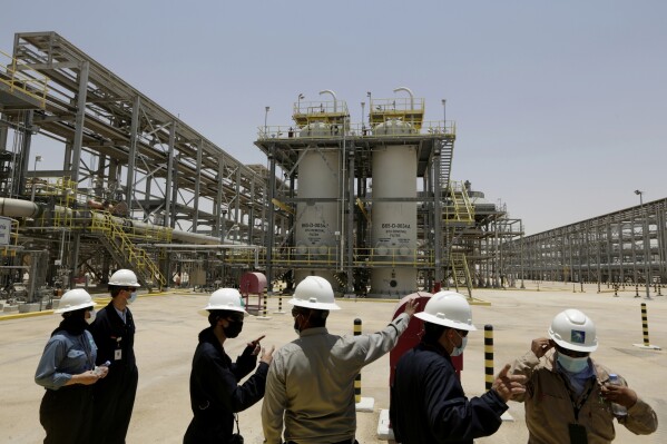 Saudi Aramco engineers and journalists look at the Hawiyah Natural Gas Liquids Recovery Plant in Hawiyah, in the Eastern Province of Saudi Arabia on June 28, 2021. (AP Photo/Amr Nabil, File)