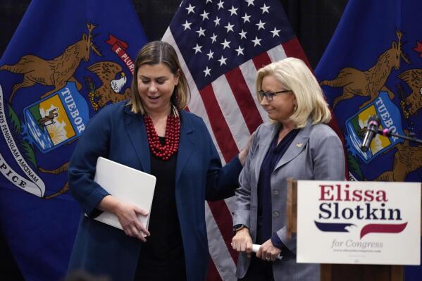 Reps. Elissa Slotkin, left, D-Mich., and Liz Cheney, R-Wyo., leave a campaign rally Tuesday, Nov. 1, 2022, in East Lansing, Mich., where Slotkin received the support of Cheney. Slotkin emphasized how a shared concern for a functioning democracy can unite Democrats and Republicans despite policy disagreements. (AP Photo/Carlos Osorio)