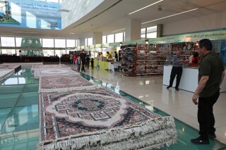 CORRECTS DATE Of PHOTOGRAPH TO JAN. 13, 2021 -- Piles of plush Iranian- made carpets line the floors of a shopping center in northern Iraq, hosting traders from neighbouring Iran, in the city of Dohuk, in the Kurdish-run northern region of Iraq, Wednesday, Jan. 13, 2021. At least 24 businesses from 15 Iranian cities offer hope that the spangle of their ornate handicrafts might offer a lifeline out of poverty for Iranians whose country's economy is in tatters amid crippling sanctions. (AP Photo/Rashid Yahya)