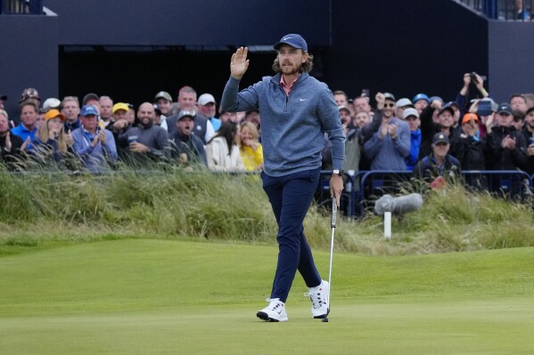 England's Tommy Fleetwood acknowledges the crowd after completing his round on the 18th green during the second day of the British Open Golf Championships at the Royal Liverpool Golf Club in Hoylake, England, Friday, July 21, 2023. (AP Photo/Jon Super)