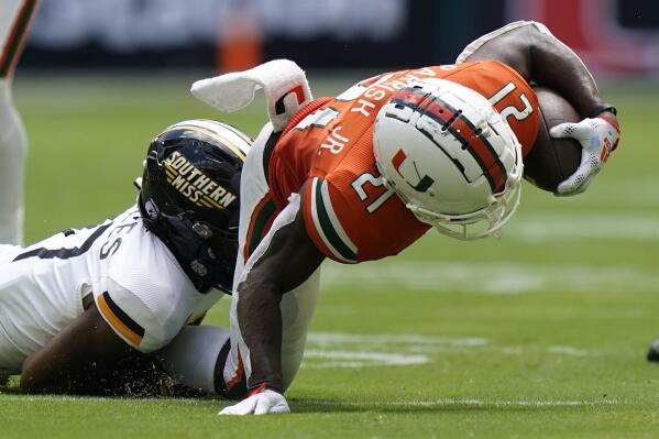 Southern Miss defensive back Brendan Toles takes down Miami running back Henry Parrish Jr. during the first half of an NCAA college football game, Saturday, Sept. 10, 2022, in Miami Gardens, Fla. (AP Photo/Wilfredo Lee)