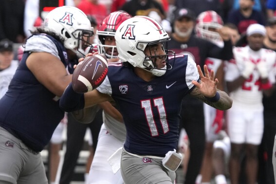 Arizona quarterback Noah Fifita throws the football against Utah during the second half of an NCAA college football game, Saturday, Nov. 18, 2023, in Tucson, Ariz. (AP Photo/Rick Scuteri)