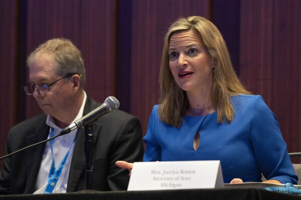 Jocelyn Benson, Michigan's Secretary of State, right, attends a panel about elections during the summer meeting of the National Association of Secretaries of State, Tuesday, July 11, 2023, in Washington. Efforts to deceive the public about voting and elections remain a top concern for state election officials as they dig into preparations for the 2024 election. (AP Photo/Jacquelyn Martin)