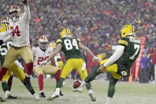 CORRECTS TO 49ERS' JORDAN WILLIS NOT ALEX BARRETT - San Francisco 49ers defensive end Jordan Willis (94) blocks a punt by Green Bay Packers punter Corey Bojorquez (7) late in the fourth quarter of an NFC divisional playoff NFL football game Saturday, Jan. 22, 2022, in Green Bay, Wis. 49ers' Talanoa Hufanga (29) ran the ball in for a touchdown. (Dan Powers/The Post-Crescent via AP)
