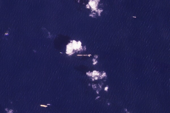 This satellite photo from Planet Labs PBC shows the USNS Roy P. Benavidez, center, in the Mediterranean Sea off shore from the Gaza Strip on Monday, April 29, 2024. A U.S. Navy ship involved in the American-led effort to bring more aid into the besieged Gaza Strip is off shore from the enclave, slowly building out a floating platform for the operation, satellite photos analyzed Monday by The Associated Press show. (Planet Labs PBC via AP)