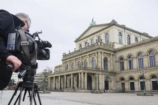 FILE - A TV cameraman films the State Opera in Hanover, Germany, Feb. 13, 2023. The Hannover State Opera said Thursday that it is ending its contract with ballet director Marco Goecke after he smeared dog feces on the face of a newspaper critic whose reviews he had taken exception to. (Julian Stratenschulte/dpa via AP, File)