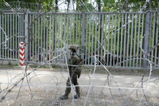 FILE - A Polish soldier patrols the border with Belarus, in Bialowieza Forest, on May 29, 2024, the day after a young soldier, Mateusz Sitek, was stabbed in the chest by a migrant who thrust a knife through a gap in the fence. He died of his wounds on June 6. The Polish parliament observed a minute of silence to honor him on Wednesday, June 12, 2024. (AP Photo/Czarek Sokolowski, File)