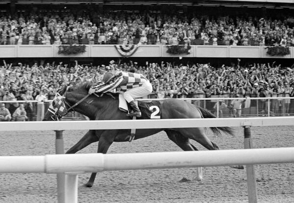 FILE - Ron Turcotte hangs on as Secretariat romps along the final stretch just before the finish line and a victory in the 105th running of the Belmont Stakes at Belmont Park in Elmont, N.Y., June 9, 1973. (AP Photo/File)