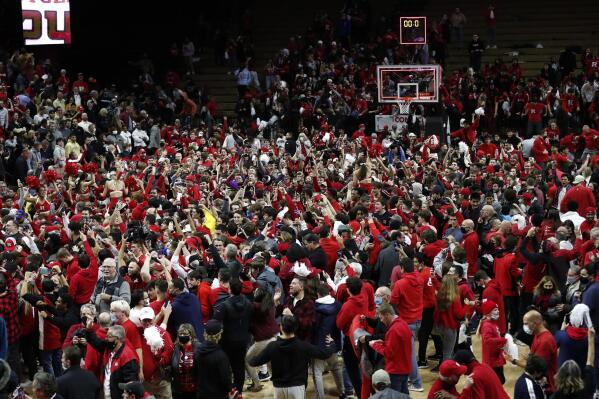 Fans gather on the court after Rutgers defeated Purdue 70-68 during an NCAA college basketball game in Piscataway, N.J., Thursday, Dec. 9, 2021. (AP Photo/Noah K. Murray)