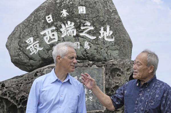 U.S. Ambassador to Japan Rahm Emanuel, left, and Yonaguni Mayor Kenichi Itokazu talk in front of a monument indicating Japan's westernmost point on Yonaguni Island in Okinawa prefecture, southern Japan Friday, May 17, 2024. Emanuel visited two southwestern Japanese islands at the forefront of tension with China's increasingly assertive actions in the regional waters. (Kyodo News via Ǻ)