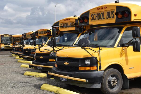 School buses parked in Helena, Mont., ahead of the beginning of the school year, Friday, Aug. 20, 2021. School districts across the country are coping with a shortage of bus drivers, a dilemma that comes even as they struggle to start a new school year during a new surge of the coronavirus pandemic.  (AP Photo/Iris Samuels)