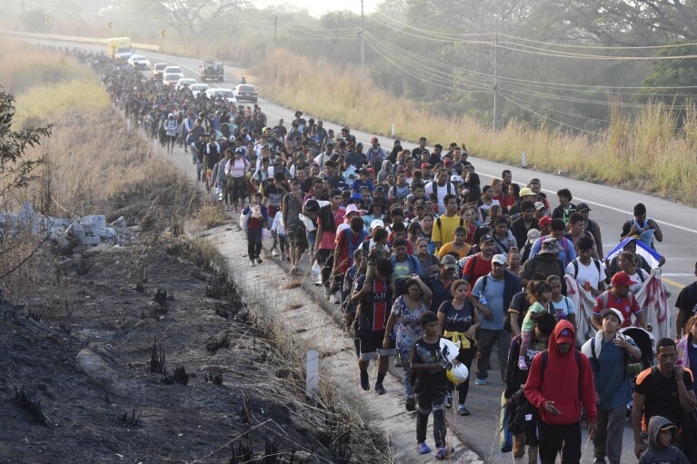 FILE - Migrants walk along the highway through Arriaga, Chiapas state in southern Mexico, Monday, Jan. 8, 2024, during their journey north toward the U.S. border. In Senegal's capital, Nicaragua is a hot ticket among travel agents serving people who want to live in the United States. Many migrants take various flights to eventually arrive there legally and then journey illegally by land to the U.S. border with Mexico. The sudden draw of the United States seems driven in large part by social media posts by those who reached their destinations successfully and travel agents who know visa rules. (AP Photo/Edgar H. Clemente, File)