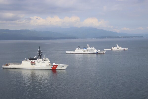 In this photo provided by Japan Coast Guard, patrol vessels of U.S. Coast Guard, left, Japan Coast Guard, center, and Philippine Coast Guard, participate in a join training off Kagoshima prefecture, southern Japan, Friday, June 20, 2025. (Japan Coast Guard via AP)