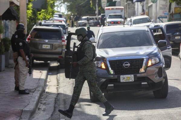 Police guard the hospital where Haiti's new prime minister, Garry Conille, was hospitalized a day prior in Port-au-Prince, Sunday, June 9, 2024. (AP Photo/Odelyn Joseph)