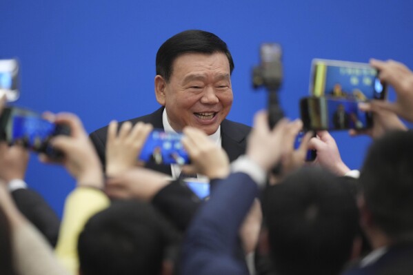 National People's Congress Speaker Lu Qingjian poses for a photo after a news conference on the eve of the National People's Congress at the Great Hall of the People in Beijing, Monday, March 4, 2024 (AP Photo/Tatan Syuflana).