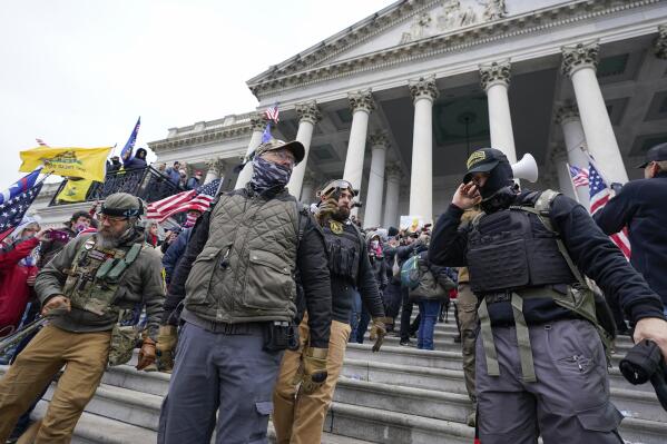 FILE - Members of the Oath Keepers extremist group stand on the East Front of the U.S. Capitol on Jan. 6, 2021, in Washington. David Moerschel, a 45,-year-old neurophysiologist from Punta Gorda, Fla., and Joseph Hackett, a 52-year-old chiropractor from Sarasota, Fla., who stormed the U.S. Capitol with other members of the far-right Oath Keepers group, were sentenced Friday to three years in prison for seditious conspiracy and other charges, the latest in a historic string of sentences in the Jan. 6. 2021 attack. (AP Photo/Manuel Balce Ceneta, File)