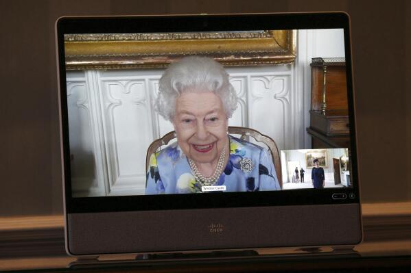 Britain's Queen Elizabeth II appears on a screen by videolink from Windsor Castle, where she is in residence, during a virtual audience to receive Her Excellency Ivita Burmistre, the Ambassador of Latvia, at Buckingham Palace, London, Tuesday April 27, 2021. (Yui Mok/Pool via AP)