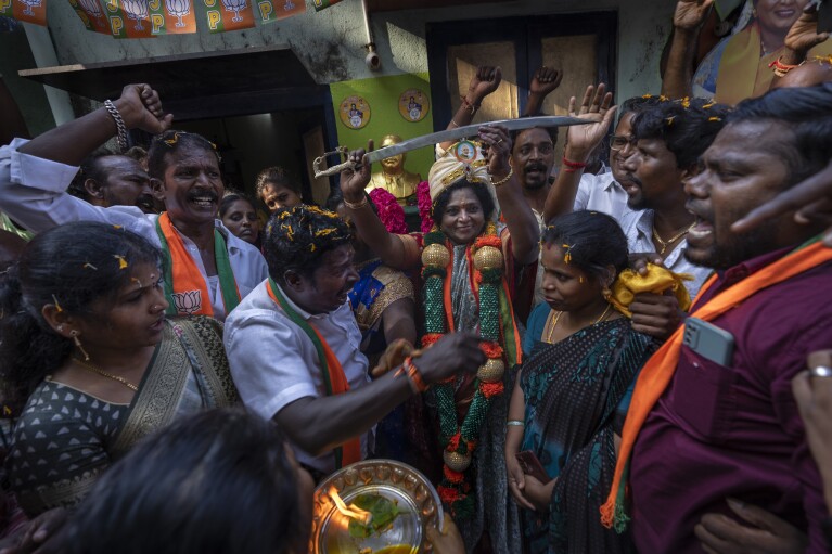 India's ruling Bharatiya Janata Party candidate Tamilisai Soundararajan, center, holds up a sword during an election campaign rally in Chennai, in the southern Indian state of Tamil Nadu, April 14, 2024. (AP Photo/Altaf Qadri)