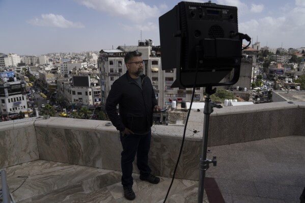 International correspondent of Al Jazeera English Zein Basravi reports live from the network's office in the West Bank city of Ramallah Sunday, May 5, 2024. Israel ordered the local offices of Qatar's Al Jazeera satellite news network to close Sunday, escalating a long-running feud between the broadcaster and Prime Minister Benjamin Netanyahu's hard-line government as Doha-mediated cease-fire negotiations with Hamas hang in the balance. (AP Photo/Nasser Nasser)