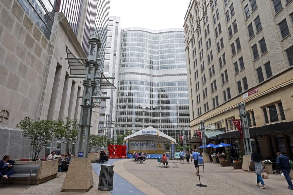 FILE - A pedestrian mall leads to the campus of the Mayo Clinic complex, center, on July 2, 2019, in Rochester, Minn. The Mayo Clinic has announced a $5 billion expansion plan that includes new buildings designed so they can evolve and expand as patient needs change over the coming decades. (AP Photo/Jim Mone, file)