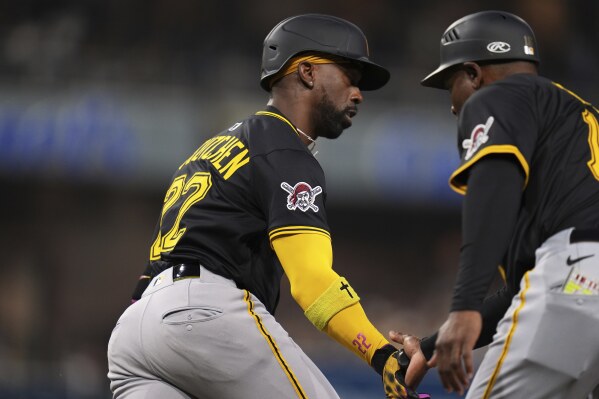 Pittsburgh Pirates' Andrew McCutchen, left, celebrates with first base coach Tarrik Brock, right, after hitting a home run during the fifth inning of a baseball game against the San Diego Padres, Saturday, May 31, 2025, in San Diego. (AP Photo/Gregory Bull)