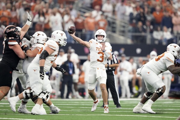 Texas quarterback Quinn Ewers throws a pass in the first half of the Big 12 Conference championship NCAA college football game against Oklahoma State in Arlington, Texas, Saturday, Dec. 2, 2023. (AP Photo/Tony Gutierrez)