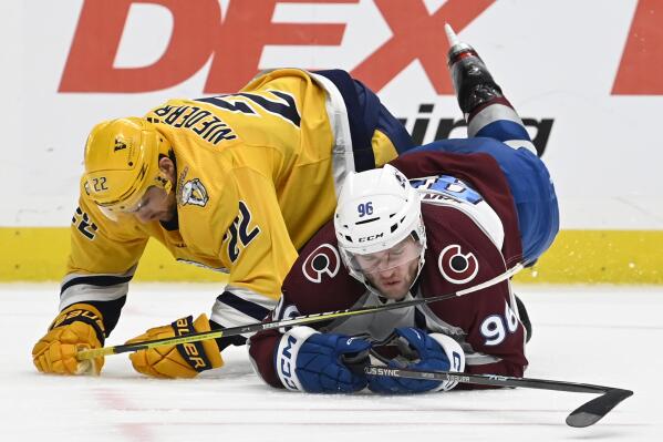 Nashville Predators right wing Nino Niederreiter (22) collides with Colorado Avalanche right wing Mikko Rantanen (96) during the third period of an NHL hockey game Friday, Dec. 23, 2022, in Nashville, Tenn. The Avalanche won in overtime 3-2. (AP Photo/Mark Zaleski)