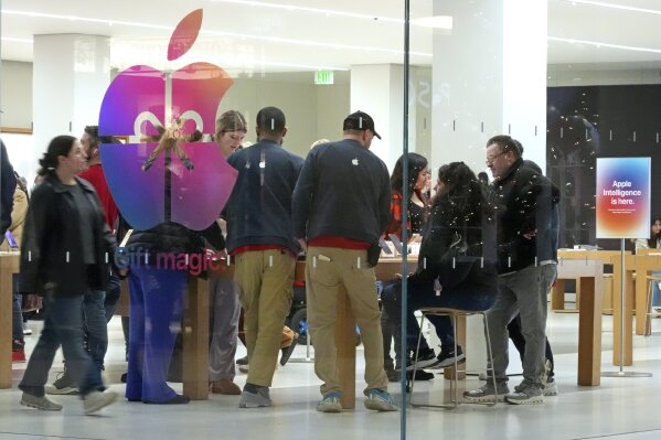 Shoppers look at Apple products in the Apple Store at the Walden Galleria in Buffalo, NY, on Saturday, Nov. 30, 2024. (AP Photo/Gene J. Puskar, File)