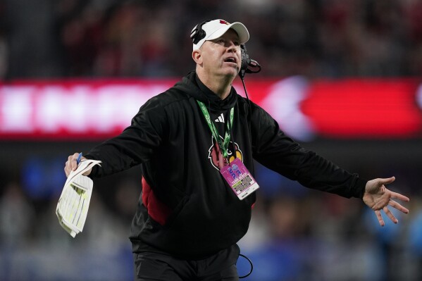FILE - Louisville coach Jeff Brohm reacts after a play during the second half of the team's Atlantic Coast Conference championship NCAA college football game against Florida State, Dec. 2, 2023, in Charlotte, N.C. Brohm or Southern California's Lincoln Riley will be getting an eggnog bath instead of a Gatorade shower as the winning coach in the Holiday Bowl. USC will play its final game as a member of the Pac-12 Conference before moving to the Big Ten next season. (AP Photo/Erik Verduzco,File)