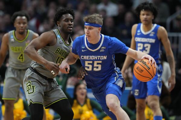 Creighton guard Baylor Scheierman, right, drives past Baylor guard Adam Flagler in the first half of a second-round college basketball game in the men's NCAA Tournament Sunday, March 19, 2023, in Denver. (AP Photo/David Zalubowski)