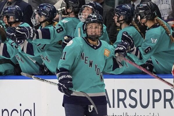 FILE - New York's Abby Roque (11) is congratulated for her goal against Montreal during the second period of a PWHL hockey game Wednesday, March 6, 2024, in Bridgeport, Conn. The inaugural season of the Professional Women's Hockey League has set one attendance record after another while putting the sport on the map across North America. (AP Photo/Frank Franklin II, FIle)