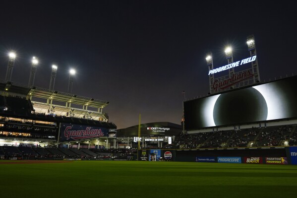 The large video screen over Progressive Field displays the total solar eclipse in Cleveland, Monday, April 8, 2024, before the Cleveland Guardians home opener baseball game against the Chicago White Sox. (AP Photo/Carolyn Kaster)