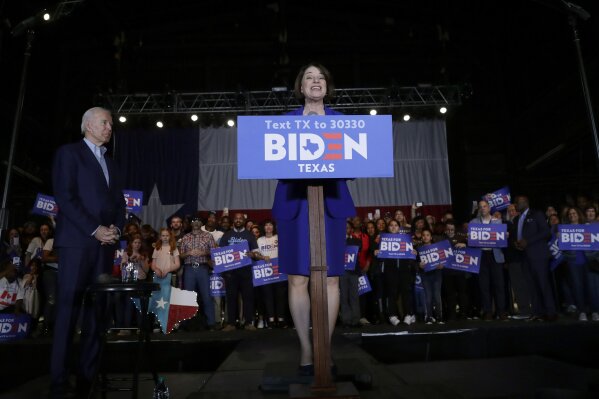 Democratic presidential candidate former Vice President Joe Biden, left, is joined by former rival Sen. Amy Klobuchar, right, as she endorses Biden during a campaign stop in Dallas, Monday, March 2, 2020. (AP Photo/Eric Gay)