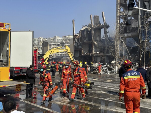Firefighters work the scene of an explosion in Sanhe city in northern China’s Hebei province on Wednesday, March 13, 2024. Rescuers were responding to a suspected gas leak explosion Wednesday in a building in northern China, authorities said. (AP Photo/Ng Han Guan)