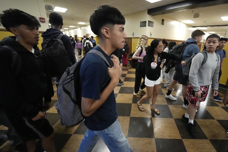 Students mix in a hallway as they change classes at Topeka High school Friday, May 10, 2024, in Topeka, Kan. Topeka is the home of the former Monroe school which was at the center of the Brown v. Board of Education Supreme Court ruling ending segregation in public schools 70 years ago. (AP Photo/Charlie Riedel)