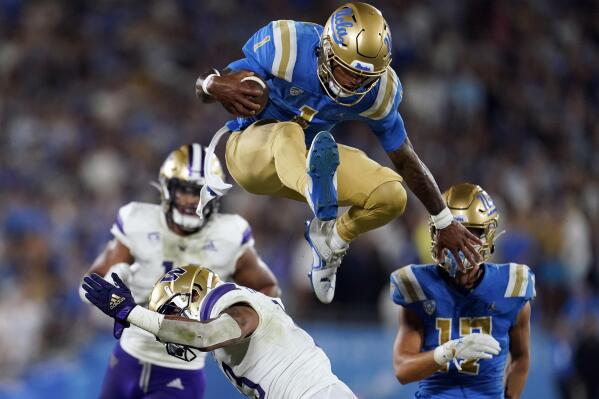 FILE - UCLA quarterback Dorian Thompson-Robinson (1) leaps over Washington linebacker Kamren Fabiculanan during the first half of an NCAA college football game on Sept. 30, 2022, in Pasadena, Calif. For Thompson-Robinson, the Sun Bowl on Friday, Dec. 30, will be his first postseason experience after appearing in 45 games over the senior's five seasons. (AP Photo/Marcio Jose Sanchez, File)