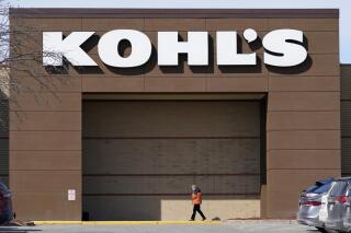 FILE - In this Feb. 25, 2021 file photo a woman arrives at a Kohl's store in West Des Moines, Iowa. Kohl's board has nixed a deal to be bought by Franchise Group, Friday, July 1, 2022, citing a poor retail environment caused by rising inflation that has consumers pulling back on spending. Wisconsin-based Kohl's was in exclusive talks with Franchise Group, the owner of Vitamin Shop and other retail outlets, on a deal worth about $8 billion.  (AP Photo/Charlie Neibergall, File)