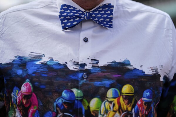 A race fan walks through the stands at Churchill Downs before the 151st running of the Kentucky Oaks horse race Friday, May 2, 2025, in Louisville, Ky. (AP Photo/Brynn Anderson)