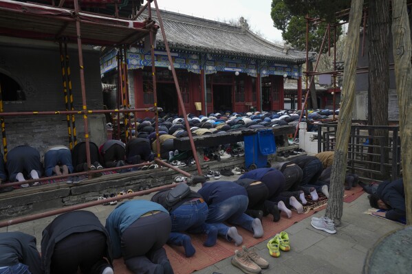 Muslim men offer the Eid al-Fitr prayers to mark the end of the holy fasting month of Ramadan at the Niujie Mosque in Beijing, China, Wednesday, April 10, 2024. (AP Photo/Tatan Syuflana)