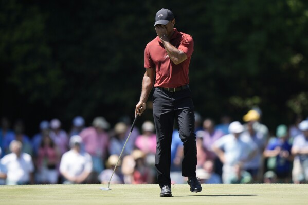 Tiger Woods wipes his face on the 15th hole during final round at the Masters golf tournament at Augusta National Golf Club Sunday, April 14, 2024, in Augusta, Ga. (AP Photo/Charlie Riedel)