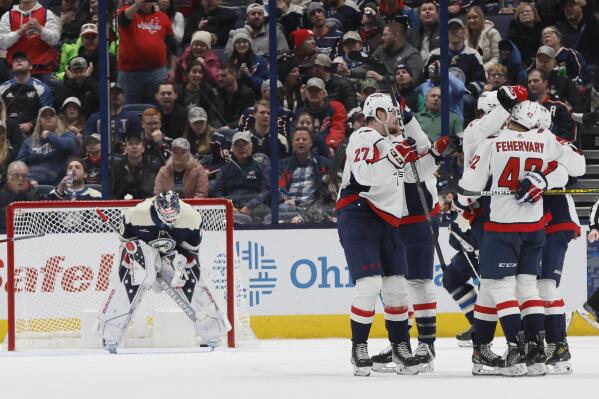 Washington Capitals players celebrate their goal against Columbus Blue Jackets' Elvis Merzlikins during the second period of an NHL hockey game on Thursday, Jan. 5, 2023, in Columbus, Ohio. (AP Photo/Jay LaPrete)