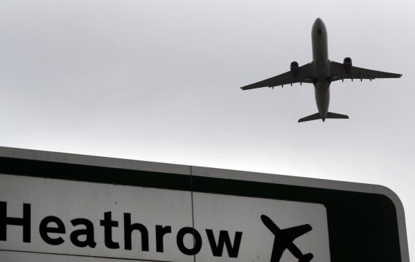 A plane takes off over a road sign near Heathrow Airport in London, June 5, 2018. (AP Photo/Kirsty Wigglesworth, File)